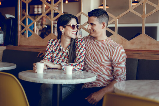 Smiling young couple at a coffee shop
