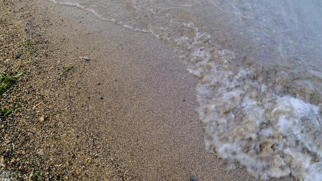 Wave runs on the sandy shore of the sea, Close Up/Pan Right