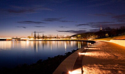 The illuminated path along the waters of Lake Burley Griffin in Canberra, Australian Capital...