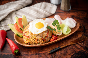 nasi goreng, indonesian fried rice on wooden plate