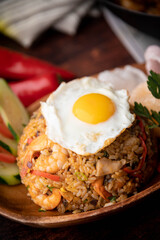 nasi goreng, indonesian fried rice on wooden plate