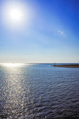 Obraz premium sunset on a pristine water and a blue sky 