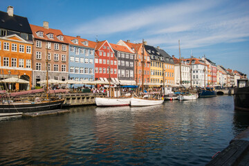 Fototapeta na wymiar Buildings and the canal of Nyhavn district in Copenhagen, Denmark, panoramic view of Nyhavn