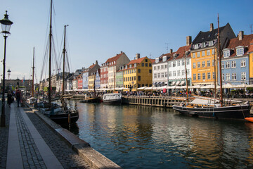 Fototapeta na wymiar Buildings and the canal of Nyhavn district in Copenhagen, Denmark, panoramic view of Nyhavn