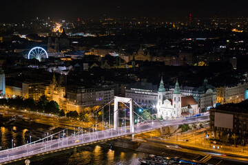 Fototapeta na wymiar Night view of Budapest and Danube with the Elizabeth Bridge, The Main Parish Church of the Assumption in the centre of Budapest at night