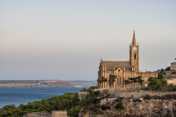 Fototapeta na wymiar Church of the Madonna of Lourdes and the sea from bird's eye view in Gozo island