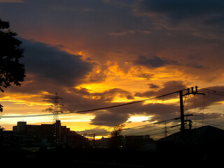 Clouds dyed orange in pursuit of the sun leaving