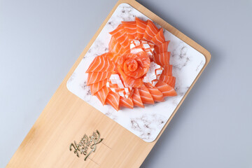 Top-view die cut of Happy birthday, Salmon sushi cake on white background isolated.