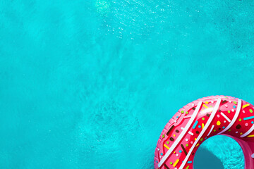 Inflatable ring floating in swimming pool, top view with space for text. Summer vacation