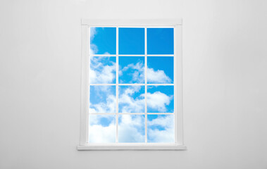 Beautiful view on blue sky with clouds through window