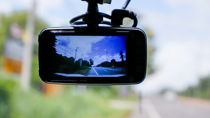 Camera on the front of a car  Background Cars on the road and clouds in the sky.