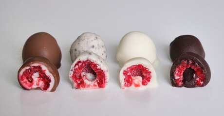 raspberries dipped or covered in mold chocolate . white chocolate, milk chocolate, dark chocolate...