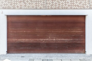 Automatic brown wood roller shutter doors on the ground floor of the house