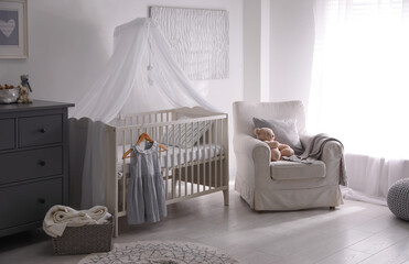 Baby room interior with comfortable crib and armchair