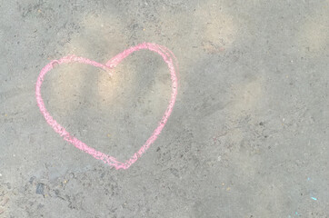 pink heart drawn with chalk on the asphalt. love confession. banner place for text, valentine,...