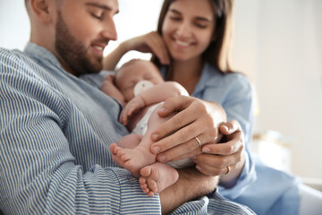 Happy couple with their newborn baby, closeup
