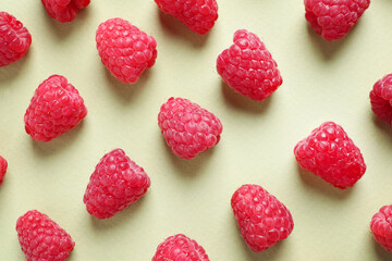 Fresh sweet ripe raspberries on light green background, flat lay