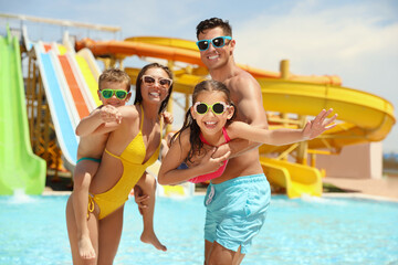 Happy family at water park. Summer vacation