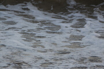 Water flowing on the beach