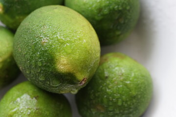 Close up of dewy limes on a plate