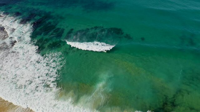 Surfer riding waves at Merewether, New South Wales