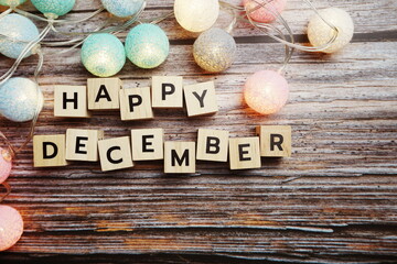 Happy December alphabet letter with LED Cotton ball Decoration on wooden background