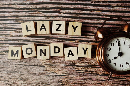 Lazy Monday alphabet letter with alarm clock on wooden background - Powered by Adobe