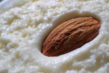 Image of almond nut on cottage cheese dessert.