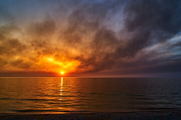 Sea sunset. Smoke wildfires sweeping across the sky.