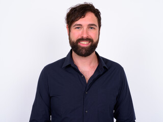 Portrait of happy handsome bearded businessman against white background