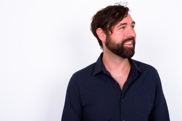 Obraz premium Portrait of happy handsome bearded businessman against white background