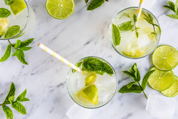 Lime and mint drink Mojito cocktail or mocktail with paper straws, seen from above