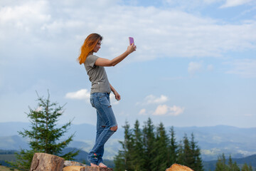 Fototapeta premium girl takes a selfie on a smartphone