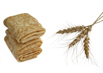 Baked spring rolls wrapped in an envelope on a white plate