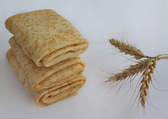Baked spring rolls wrapped in an envelope on a white plate