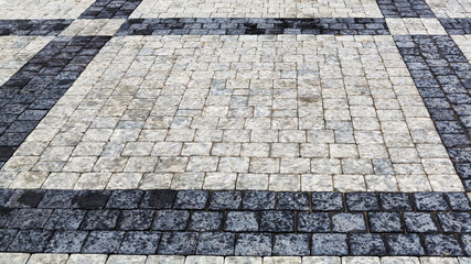 Decorative sidewalk pavement. Tiled floor with gray and black tiles, double-crossed by a diagonal strip of marble viewed at a low angle, full frame background image
