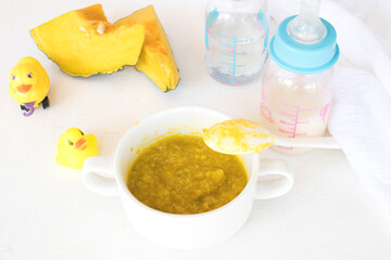 mix rice gruel with  pumpkin healthy foods and water ,milks bottles health care for baby eats breakfast arrangement flat lay style on background white 