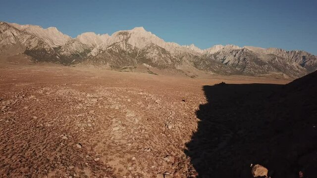 aerial shot of a dry wash in the Alabama Hills area of California with a view of the high sierras. 