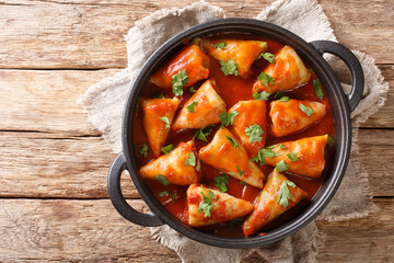 cabbage rolls stuffed with ground beef and rice and baked with a hot tomato sauce close-up in a bowl. Horizontal top view