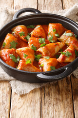 Delicious hot cabbage rolls with meat and rice in tomato sauce close-up in a bowl on the table. vertical