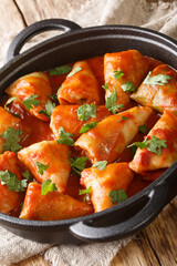 Ukrainian national dish cabbage rolls with meat and rice close-up in a bowl on the table. vertical