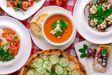 Pumpkin soup with feta cheese and vegetables, dietary vegan salad. Mix of Italian Vegetarian dishes.