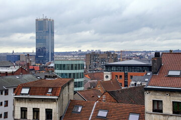 Obraz premium view of oldtown architecture with red tiled rooftops and modern cityscape in background, Brussels, Belgium