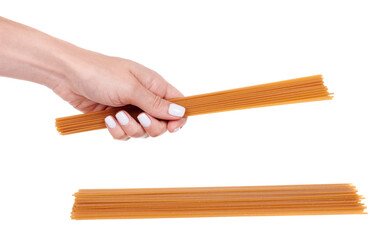 Hand with dark durum wheat spaghetti, raw pasta, isolated on white background.