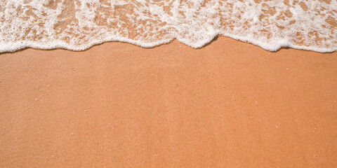 Tourist travel banner design template, copy space. White foam of a sea wave, golden sand beach, turquoise ocean water.