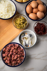 Zutaten  für Norddeutscher Hamburger Labskaus mit Rindfleisch Corned Beef, Rote Beete, Kartoffeln, Saure Gurken, Zwiebeln, Ei und Rollmops auf Marmor Arbeitsfläche