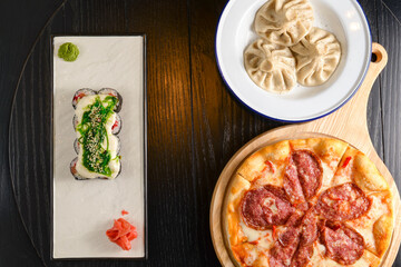 Composition of pizza, sushi and dumplings for fast food illustration. Different meals served. Copy space banner.
