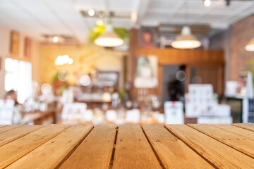 Naklejka na ściany i meble Selective focus of wooden table with blur coffee and restutant cafe with customers.