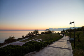 Antalya, Turkey - December 18, 2019: Embankment with people in evening in Antalya in Turkey