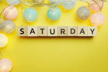 Saturday alphabet letter with LED Cotton ball Decoration on yellow background